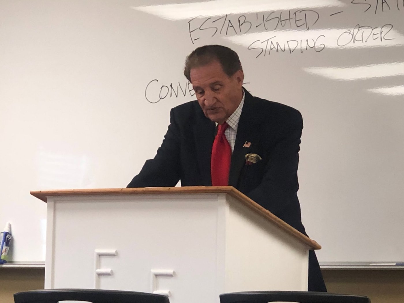 A professor teaching from the podium